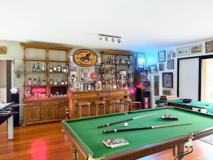 a room with a pool table and a bar at Le Grand Hôtel Le Touquet-Paris-Plage in Le Touquet-Paris-Plage