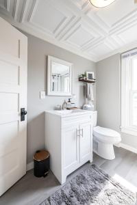 a white bathroom with a sink and a toilet at Hannahs Haven in Lima +47 photos