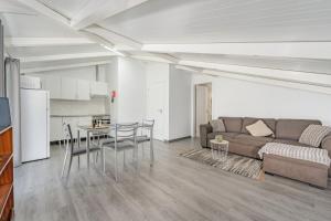a living room with a couch and a table and chairs at Casa Vale da Laurissilva in São Vicente