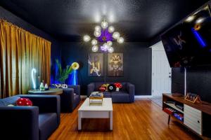 a living room with a couch and a chandelier at 5 Bedroom Home 10 Min Drive To Downtown in Denver