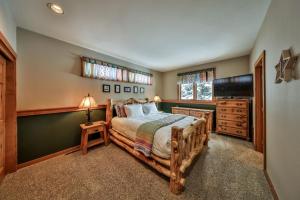 a bedroom with a bed and a dresser and a window at Rocky Mountain Retreat Steps to Slopes with Hot Tub and Spectacular Views in Winter Park