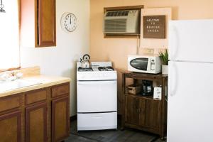 a kitchen with a white stove and a refrigerator at Beaver Creek Cabin 2 in Strasburg