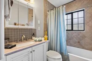 a bathroom with a sink and a toilet and a shower at Cozy Hideaway in Denison Tx in Denison