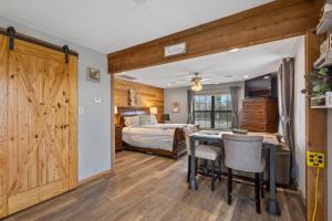 a bedroom with a bed and a table and chairs at Cozy Hideaway in Denison Tx in Denison