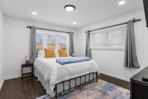 a bedroom with a bed with yellow pillows and a window at Dallas Retreat Pool & Patio Near AT&T Stadium in Dallas +28 photos