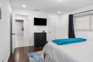 a bedroom with a bed and a flat screen tv at Dallas Retreat Pool & Patio Near AT&T Stadium in Dallas