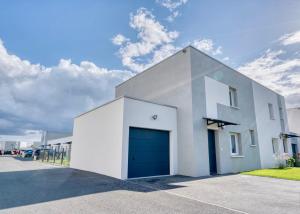 a white building with a blue garage door at Casa Via - Entre Caen & la mer in Cambes-en-Plaine