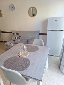 a table with a wine glass on top of it at Appartement proche des thermes in Balaruc-les-Bains