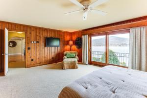 a bedroom with a bed and a large window at Private Dock at Lake George Getaway in Lake George