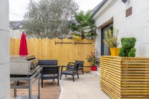 a teddy bear sitting on a table in a patio at La Maison de Papy Ours,Family ,Air-conditioned in Bourré