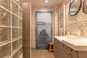 a bathroom with a door with a view of a pier at La Maison de Papy Ours,Family ,Air-conditioned in Bourré +27 photos
