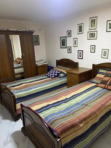 a bedroom with two beds and a mirror at Yerevan Guesthouse B&B in Yerevan +37 photos