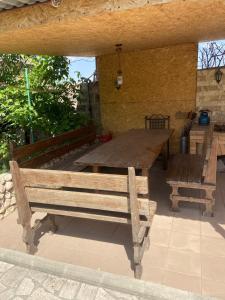 a wooden table and benches on a patio at Yerevan Guesthouse B&B in Yerevan