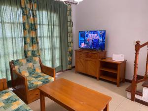 Televízia a/alebo spoločenská miestnosť v ubytovaní Casa Teresa. Duplex en Maspalomas
