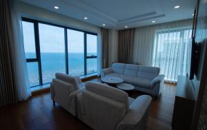 Una sala de estar con un sofá y sillas y una mesa. en Khách sạn Vũ Phong Prime, en Sầm Sơn