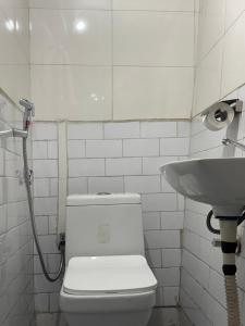 a bathroom with a toilet and a sink at Sparid Inn in Darjeeling +15 photos
