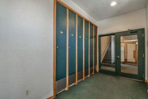 an empty room with a hallway with a glass door at Quicksilver 1613 by SummitCove Lodging in Keystone +35 photos
