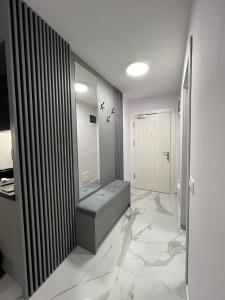a bathroom with a bench on a marble floor at Center Park Apartment in Sandanski