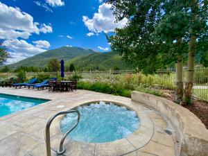 a pool with a hot tub in the middle of a yard at Red Hawk Lodge 2297 by SummitCove Lodging in Keystone
