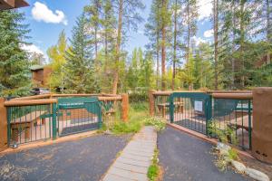 a gate in a fence with trees in the background at Starfire 1992 by SummitCove Lodging in Keystone