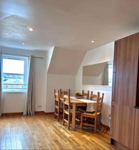 a kitchen and dining room with a table and chairs at Cosy City Centre Apartment in Inverness