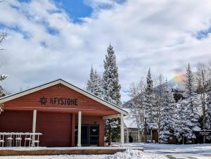 a hospice building in the snow with a rainbow in the background at Ski Run 501 by SummitCove Lodging in Keystone