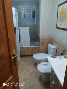 a bathroom with two toilets and a shower at Bienvenida in Almería