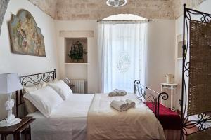 Postel nebo postele na pokoji v ubytování Trullo Sorluca - relax e comfort per famiglie nella Valle d'Itria + 69 fotografií