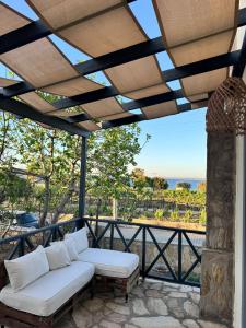 a patio with a couch and a view of the ocean at Nills butik otel in Bozcaada +56 photos