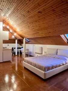 a bedroom with a bed and a wooden ceiling at CASTAGNETO 8 in Rapallo