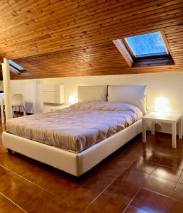 a bedroom with a bed with a wooden ceiling and a window at CASTAGNETO 8 in Rapallo +4 photos
