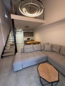 a living room with a couch and a table at RoomElioti Apartments in Ofrínion