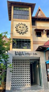 a building with a lion painted on the side of it at BaBa Boutique House Langkawi in Pantai Cenang