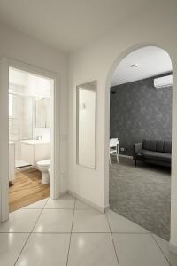 a white bathroom with a sink and a mirror at AR Palace Hotel - Palermo in Isola delle Femmine +37 photos