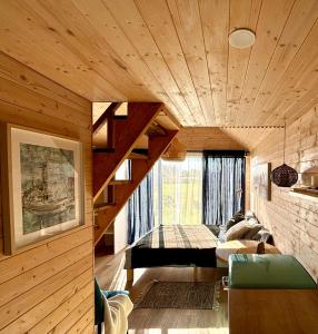 a living room with a wooden ceiling and stairs at Rita Sapnis in Nida