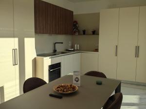 a kitchen with a table with a bowl of food on it at Penthouse in Afragola