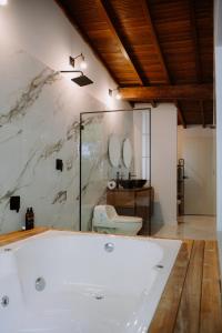 a white tub in a bathroom with a toilet at Suite con jacuzzi en El Poblado in Medellín