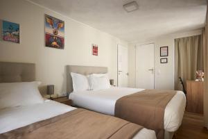 a hotel room with two beds and a window at Hotel des Congrès et Festivals in Cannes