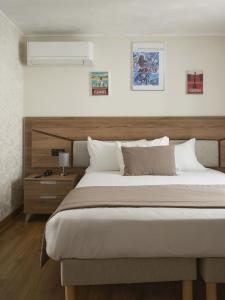 a bedroom with a large bed with a wooden headboard at Hotel des Congrès et Festivals in Cannes