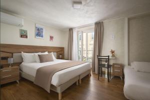 a hotel room with a large bed and a chair at Hotel des Congrès et Festivals in Cannes