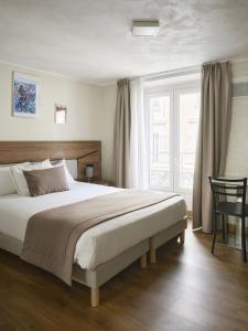 a bedroom with a large bed and a window at Hotel des Congrès et Festivals in Cannes