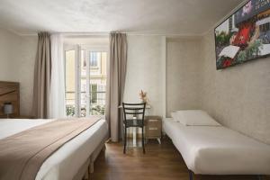a hotel room with two beds and a chair at Hotel des Congrès et Festivals in Cannes