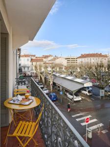 a balcony with a table and chairs and a parking lot at Hotel des Congrès et Festivals in Cannes