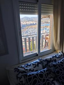 a window with a couch in a room with a view at La Bella Vista in Puerto de Mazarrón +15 photos