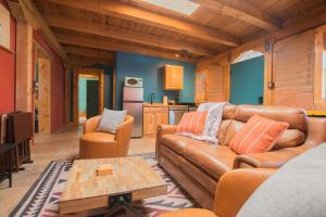 a living room with a couch and a table at 3 King Beds Hot Tub Arcades 5 Baths in Albuquerque