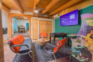 a living room with a ping pong table and chairs at 3 King Beds Hot Tub Arcades 5 Baths in Albuquerque