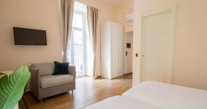 A bed or beds in a room at Musto Suites & Rooms