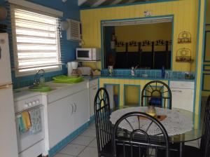 a kitchen with a table and a table and chairs at Sun Caraibes in Orient Bay