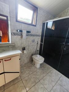 a bathroom with a shower and a toilet and a sink at POUSADA FLOR DE LIS in Diamantina +175 photos
