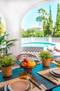 a table with fruits and vegetables on a table with a pool at Casa Dona in Denia
